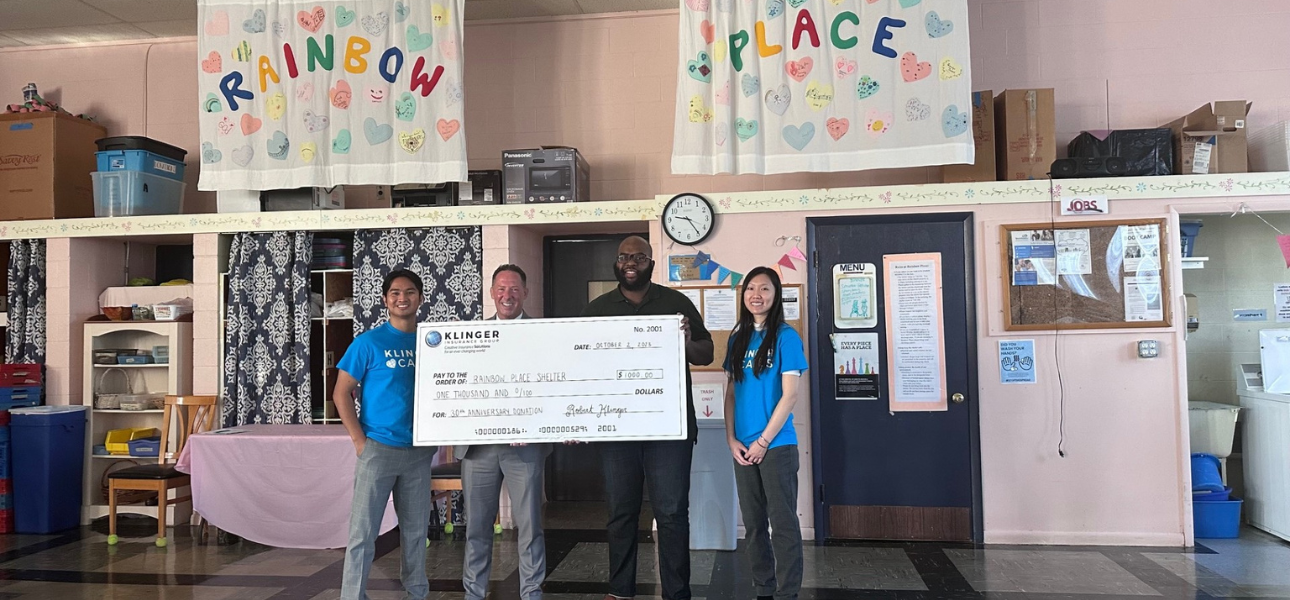 Klinger Cares team members interacting with residents at Rainbow Place Shelter, sharing smiles and support