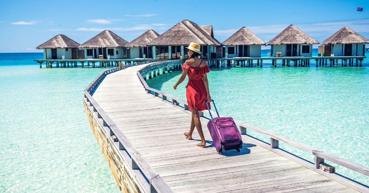 A serene beach destination with crystal-clear water, representing worry-free travel with Klinger Insurance Group.