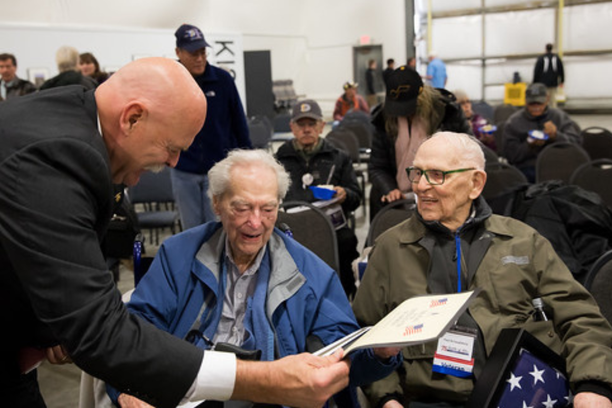 Veteran-owned business owner reviewing insurance options with an advisor