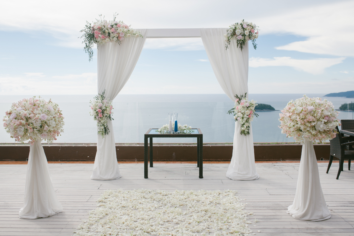 A calm and serene wedding setup with gentle lighting, lush greenery, and a tranquil atmosphere