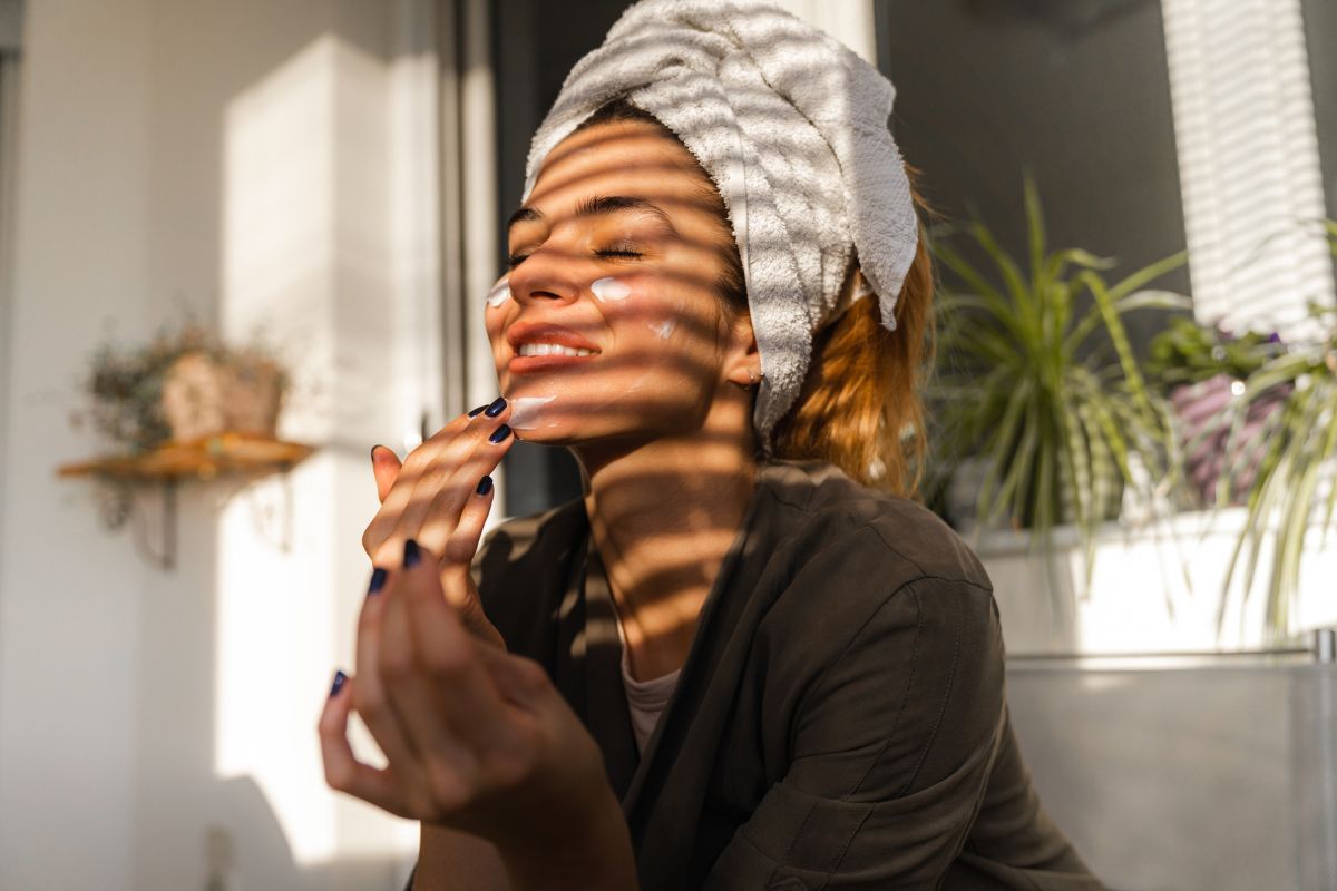 A woman enjoying a peaceful moment with a cup of tea, symbolizing self-care and relaxation on International Self-Care Day.