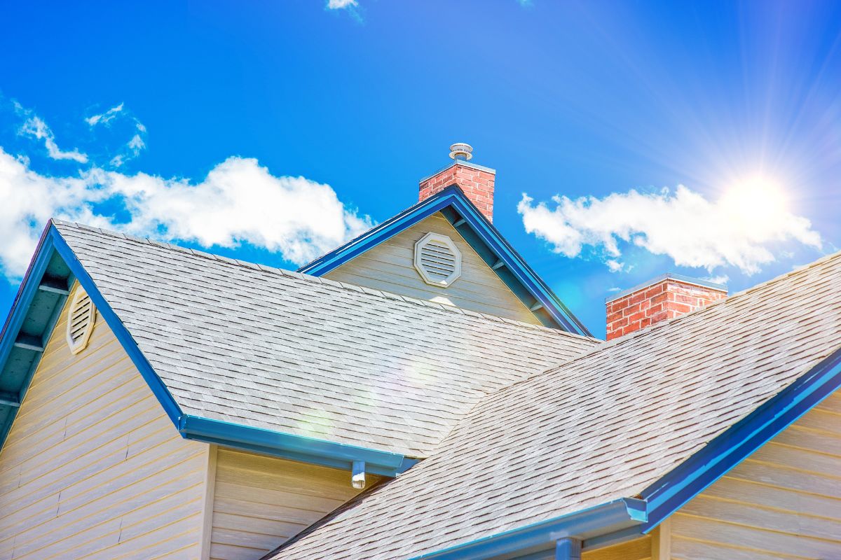 A house roof under a clear blue summer sky