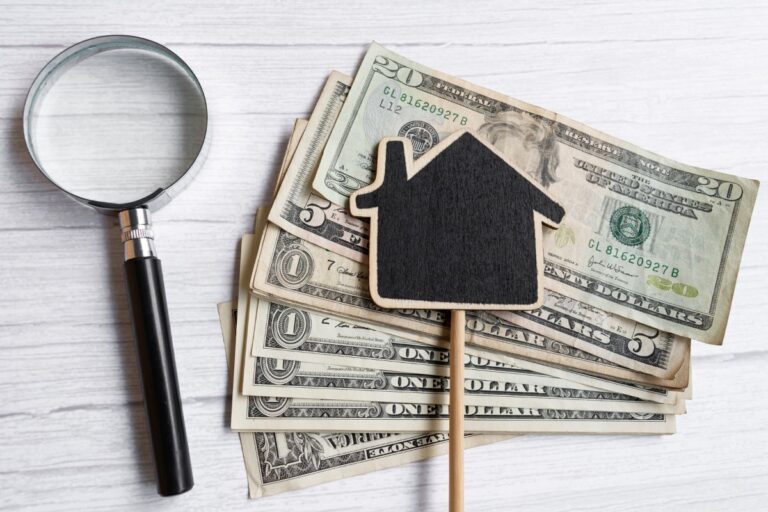 Illustration of a house with money surrounding it, representing True Replacement Cost insurance coverage for rebuilding or replacing property.