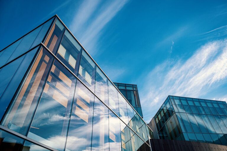 Modern commercial building with large glass windows and signage, representing a business space—ideal for illustrating Commercial Property Insurance coverage.