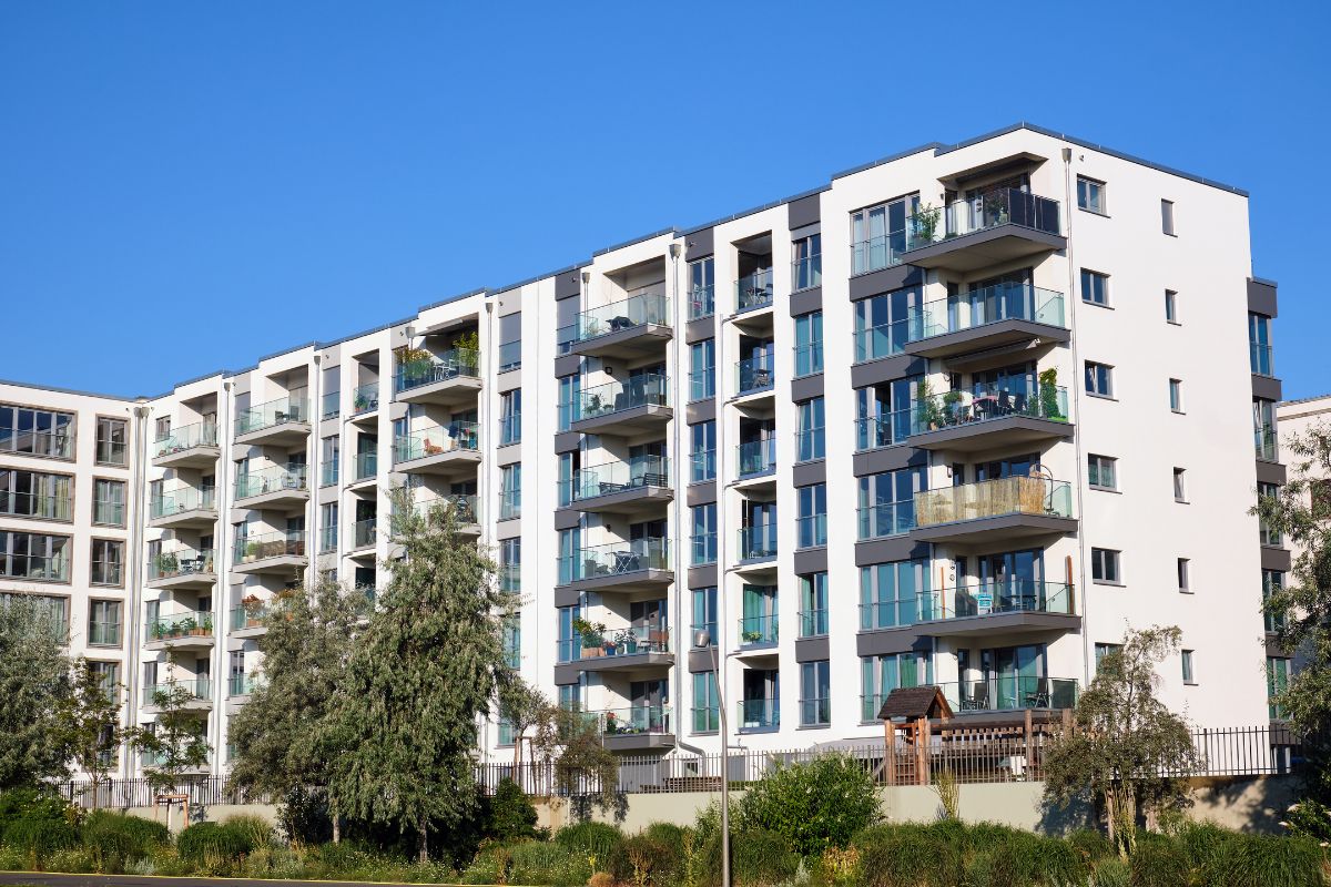 Modern condominium building available for rent with balconies and large windows.