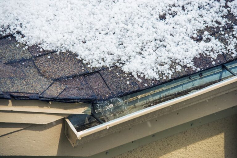 A suburban home with a reinforced roof and storm shutters, designed to prevent wind and hail damage during severe weather.
