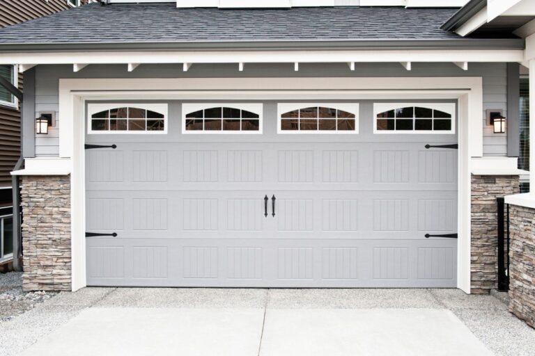 Homeowner performing fall garage maintenance, checking tools and cleaning to prepare for the colder months.