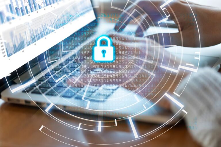 Business owner reviewing cybersecurity protection plan on laptop to prevent cyberattacks and data breaches.
