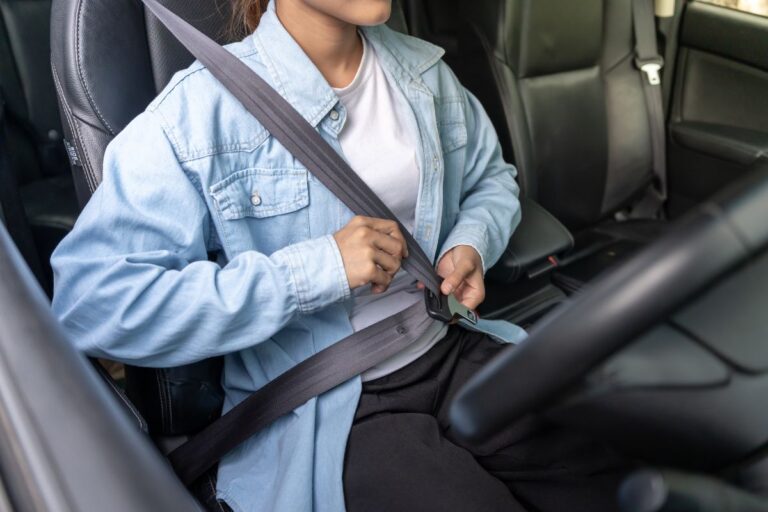Driver staying alert and focused while traveling on a decorated holiday road at night.