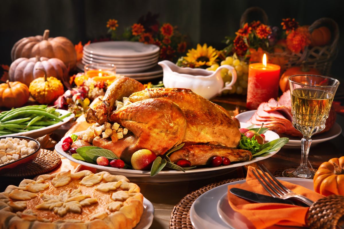 A family preparing Thanksgiving dinner together in a warm kitchen, focusing on safety while cooking to prevent holiday accidents.