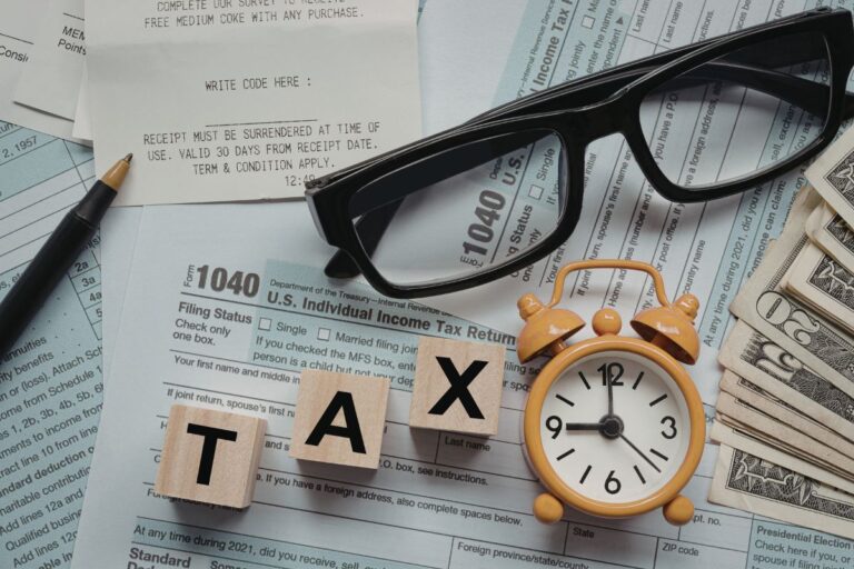 Person reviewing finances and insurance documents during tax season to protect assets