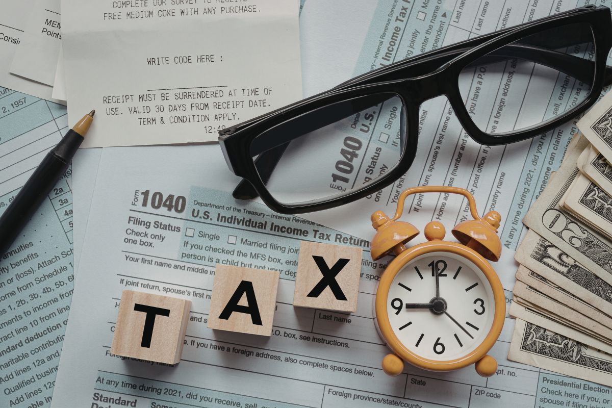 Person reviewing finances and insurance documents during tax season to protect assets