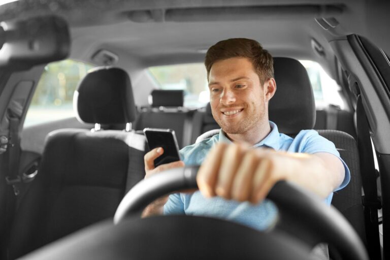 Driver keeping both hands on the wheel while staying focused on the road during a safe driving check.