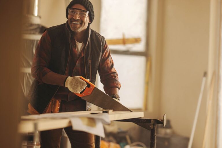 Contractor working on-site reviewing tools and project plans at a job location