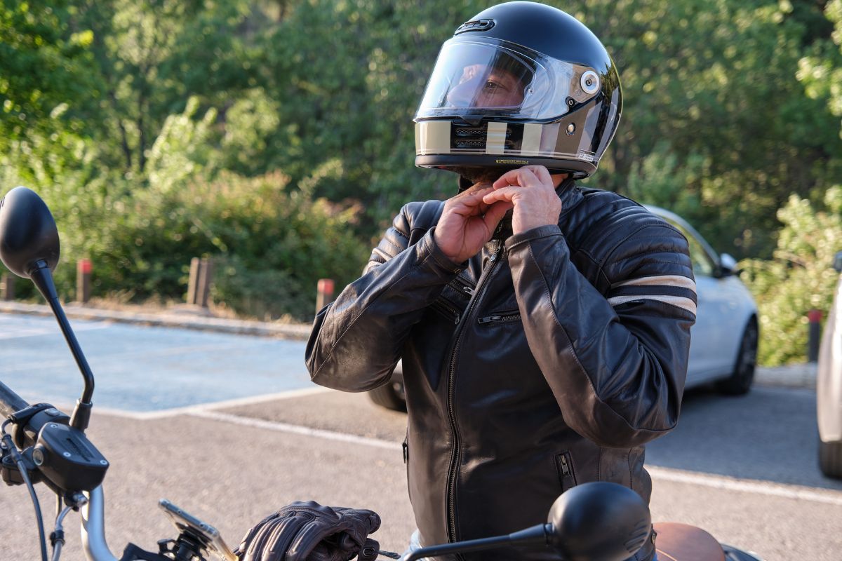 Motorcyclist wearing helmet and protective gear riding safely on the road during Motorcycle Safety Month