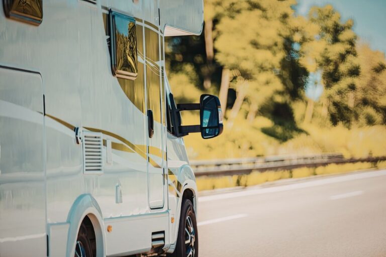 RV parked outdoors with a focus on its tires, highlighting the importance of regular tire care and maintenance for safe travel.