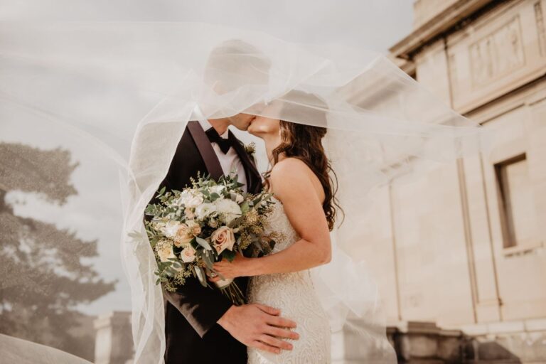 Wedding couple with a protective shield symbolizing wedding insurance coverage