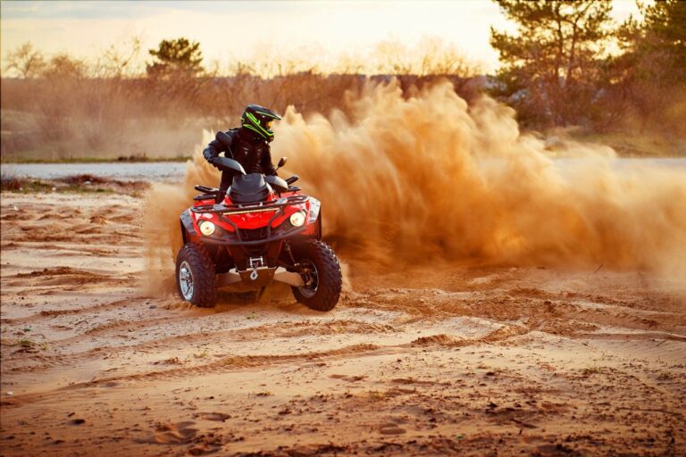 ATV rider reviewing insurance coverage documents while standing beside an all-terrain vehicle before an outdoor trail ride.