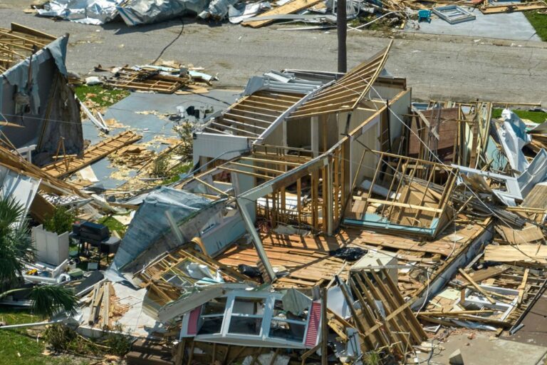 A house surrounded by storm clouds and heavy rain, representing natural disaster risks and home insurance coverage.
