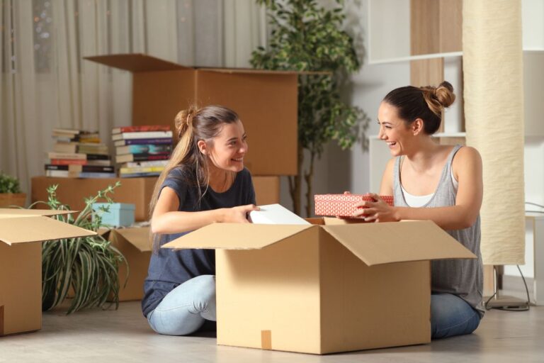 Two roommates reviewing a renters insurance policy together in their shared apartment.
