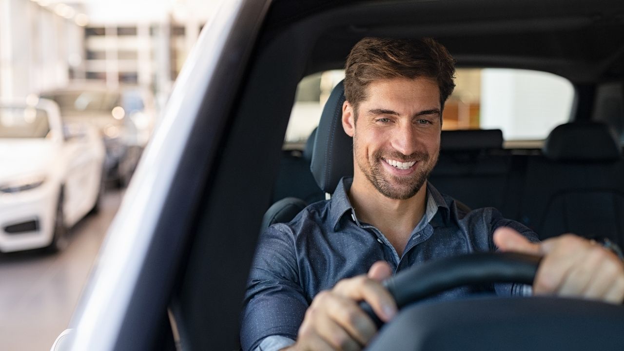 Driver checking insurance coverage before driving someone else’s car.
