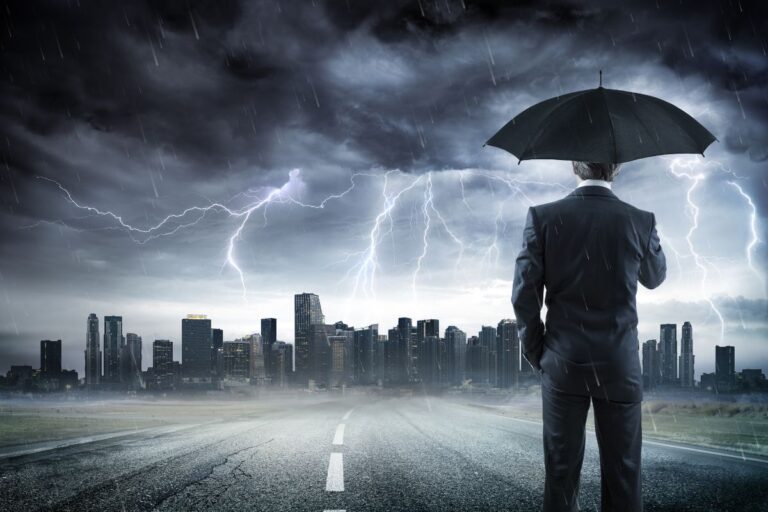 Business owner reviewing a disaster preparedness and risk management plan to protect business operations and minimize potential losses