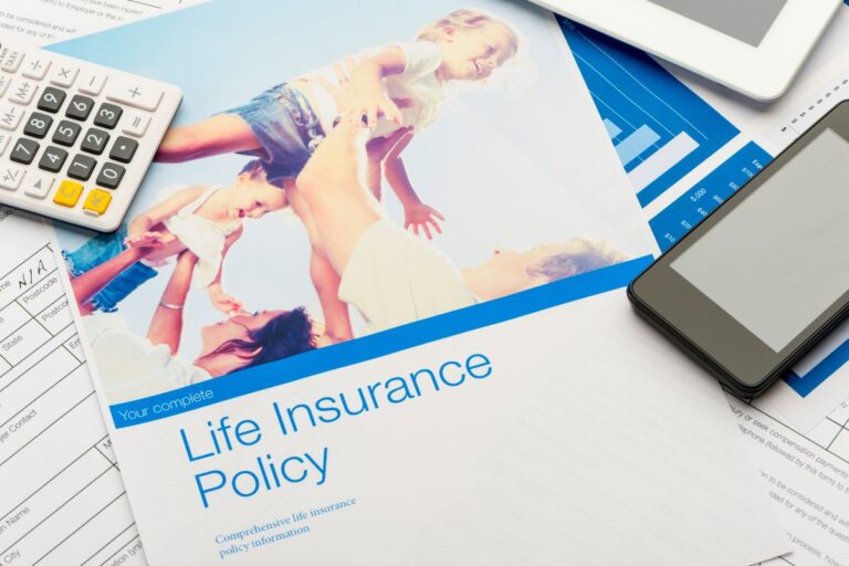 Family reviewing household bills and financial plans with life insurance documents